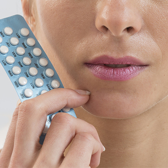 Photo d'une personne tenant une plaquette de pilule contraceptive dans sa main